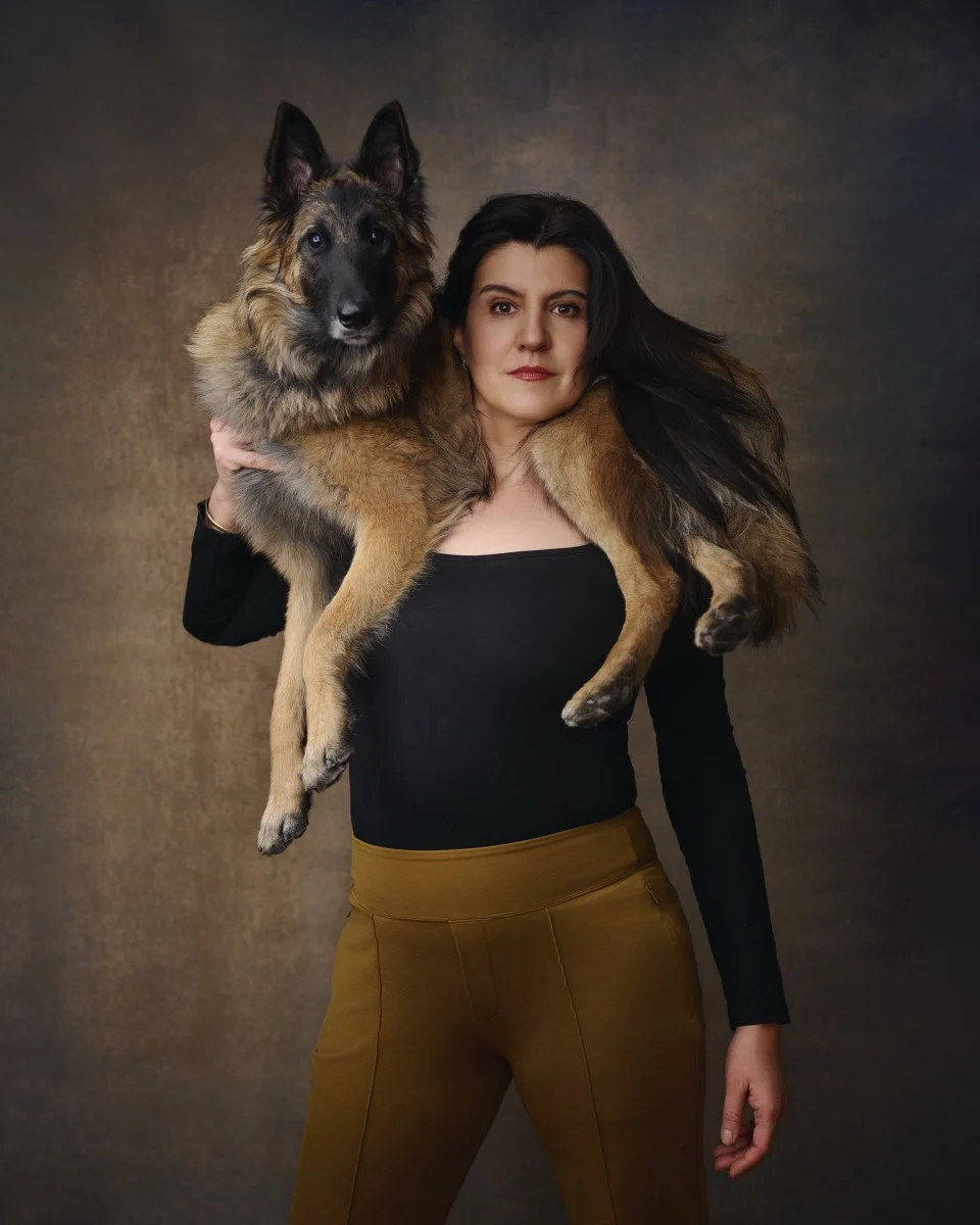 Marie Feutrier with dog Penny in casual outdoor portrait
